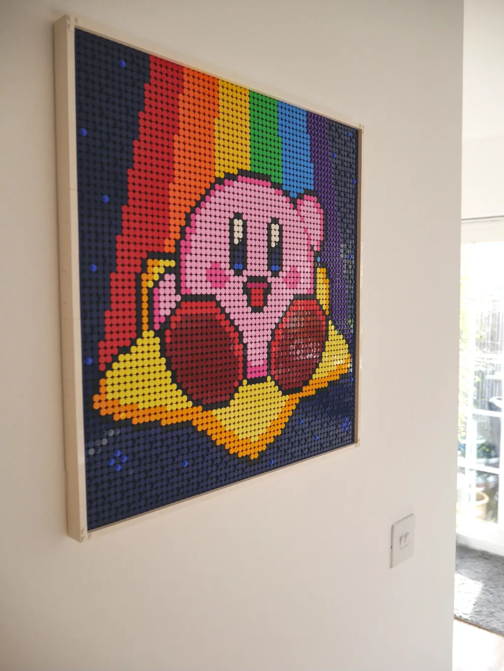 Lego Kirby artwork hanging on wall